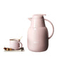 Pink Feenik glass insulated jug vacuum flask beside matching gold-rim mug and sugar cubes for tea and coffee