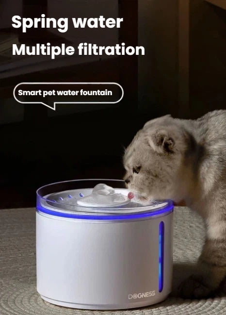Fluffy gray cat drinking from Dogness automatic water fountain with glowing blue LED light; smart pet hydration device designed to encourage increased water intake
