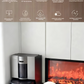 The ECOVACS X11 Omni robot vacuum docked at its sleek, silver all-around base station next to a modern fireplace, with a small white dog sitting nearby. The image highlights features like hot air drying and automatic dust collection for worry-free cleanliness.