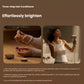 Woman using Laifen Swift 4 hair dryer with essential oil dropper, applying nourishing oil to hydration chamber for healthy, shiny hair care.