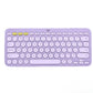 Pastel lavender Logitech K380 keyboard viewed from above, emphasizing its trendy color and the ability to switch between three Bluetooth devices with one tap.