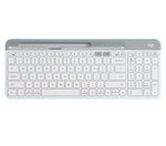 Clean overhead view of the off-white Logitech K580 wireless keyboard, highlighting its ultra-thin profile, integrated device slot, and quiet low-profile keys.