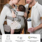 Mother wearing Nuna Cudl Clik Carrier with newborn in front-facing-in position. Features highlighted: ergonomic design, magnetic snap fasteners, and International Hip Dysplasia Institute recommendation. Partner standing beside her holding water bottle.