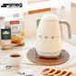 The iconic cream Smeg KLF04 Variable Temperature Kettle sitting on a wicker placemat as part of a cozy breakfast scene, perfect for brewing the ideal cup of tea.