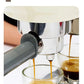 A close-up action shot of the Smeg ECF02 portafilter extracting two streams of rich, balanced espresso with perfect crema into glass cups, demonstrating its low-pressure pre-extraction technology.