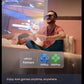 Man wearing XR glasses and VITURE One Neckband, streaming AAA games via PXPlay/XBXPlay while partner sleeps.