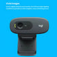  Front view of the C270 webcam against a bright blue background, illustrating automatic lighting adjustment for clearer, brighter video.