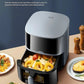 The Yamazen air fryer's open 5.5L basket is filled with food, surrounded by various delicious dishes like fried shrimp, lamb chops, and salmon, showcasing its large capacity for parties and family meals.