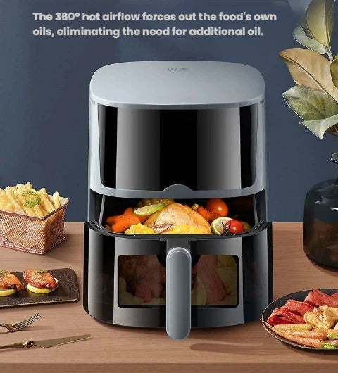 The Yamazen 5.5L air fryer on a kitchen counter, with the basket open to show cooked chicken and vegetables, illustrating the 360-degree hot airflow technology that eliminates the need for extra oil.