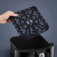 A close-up demonstrating the easy cleaning process of the Yamazen air fryer, showing a hand lifting the removable, non-stick grill rack from the detachable frying basket.
